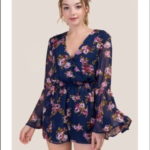 Francesca's Miami Floral Ruffle Romper in Navy